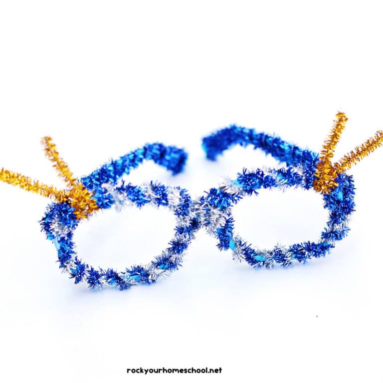 Example of DIY New Year's Eve glasses craft for kids with blue, silver, and gold pipe cleaners.