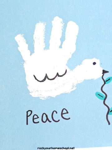 Example of white handprint dove craft for kids with Peace.