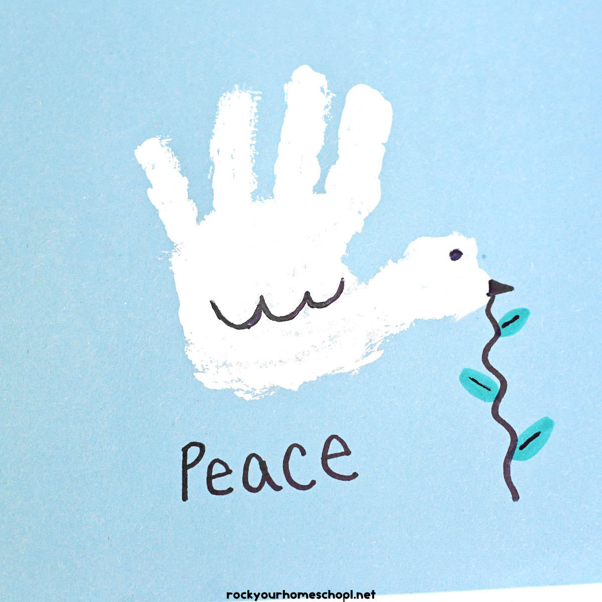 Example of white handprint dove craft for kids with Peace.