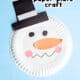 Snowman paper plate craft with construction paper hat, eyes, and nose.