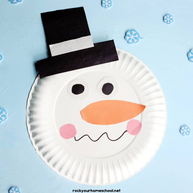 Example of snowman paper plate craft with snowflake mini-erasers.