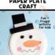 Snowman paper plate craft with black paper hat and orange nose and snowflake mini-erasers.