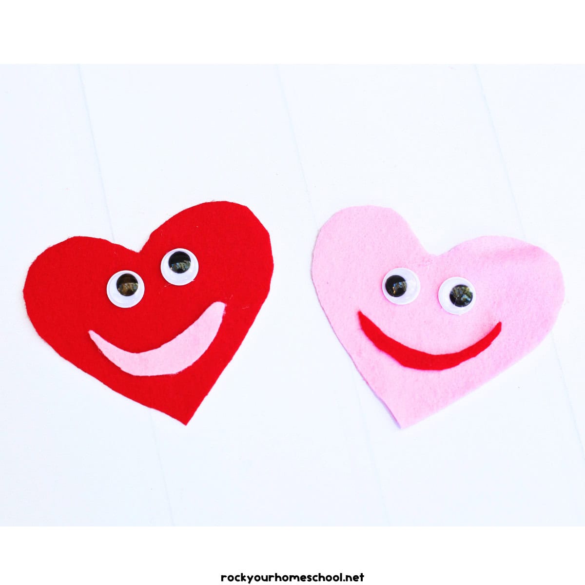 Red and pink felt hearts with googly eyes and smile shapes.