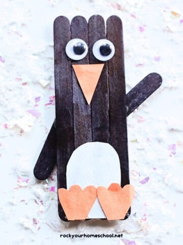 Example of cute penguin popsicle stick craft for kids with googly eyes and construction paper.