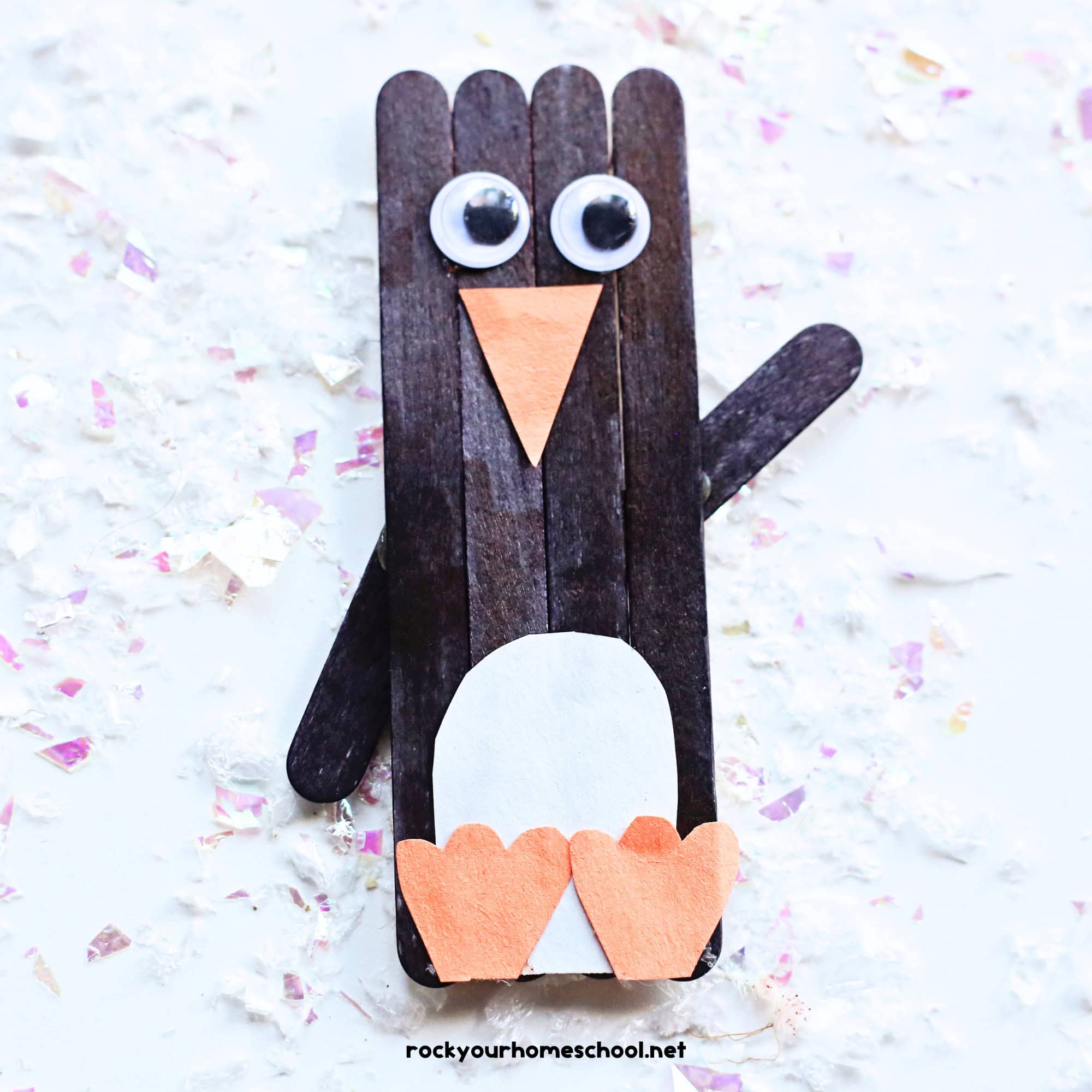 Example of cute penguin popsicle stick craft for kids with googly eyes and construction paper.