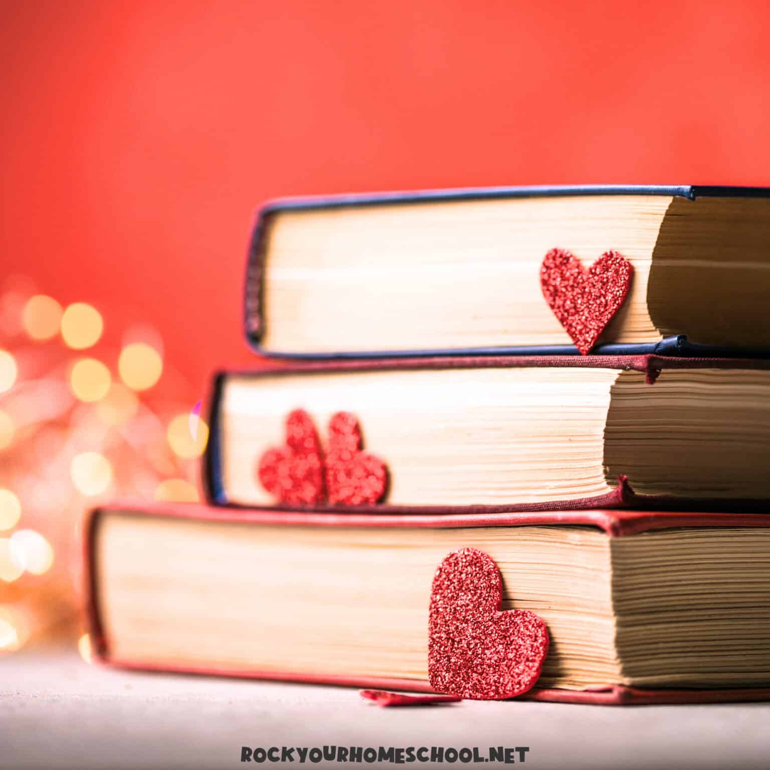 Stack of books with hearts and twinkling lights to feature February homeschool ideas.