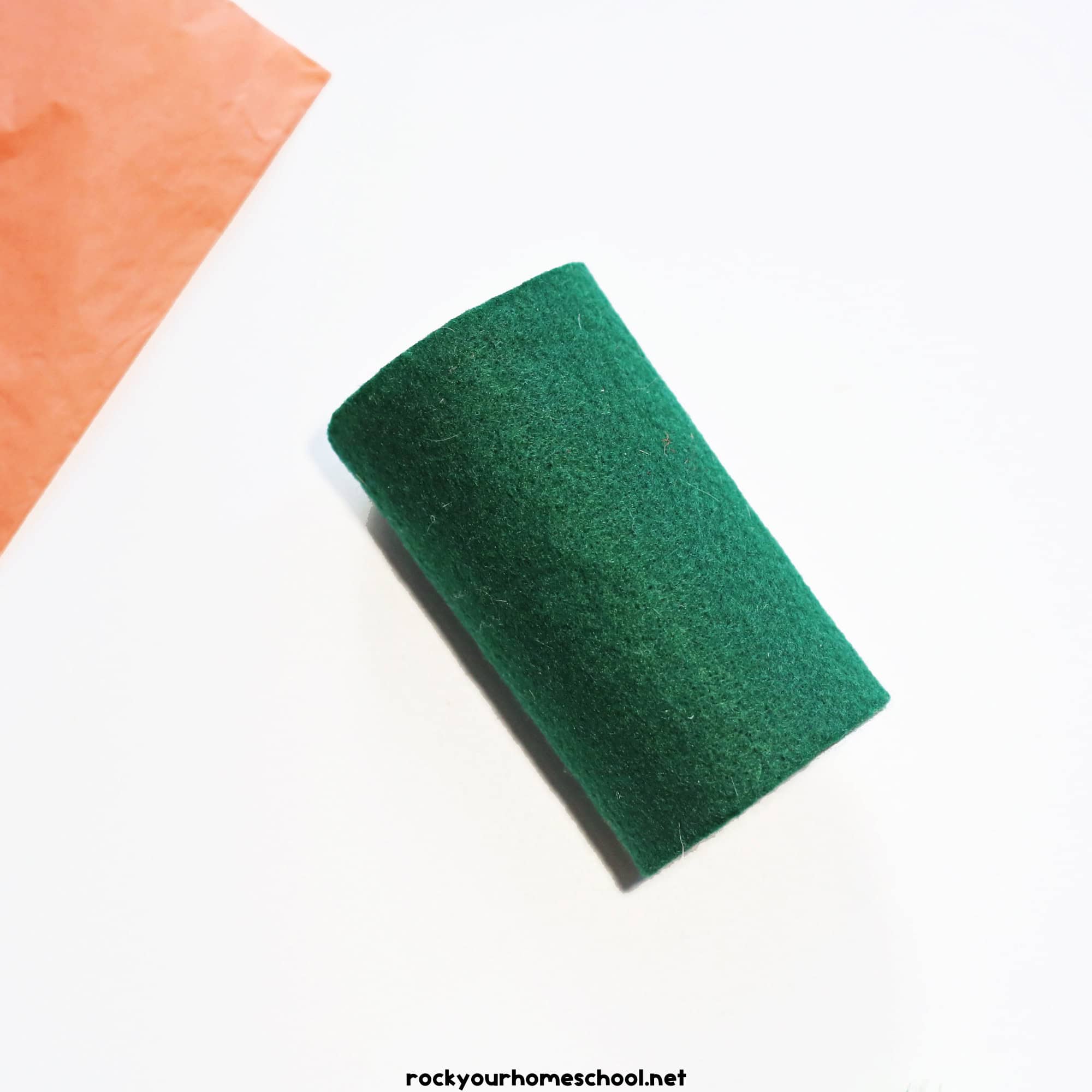 Toilet paper roll wrapped in green felt.