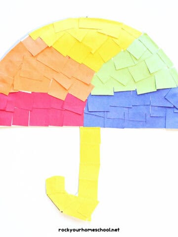 Example of paper plate umbrella craft in red, orange, yellow, green, and blue paper squares.