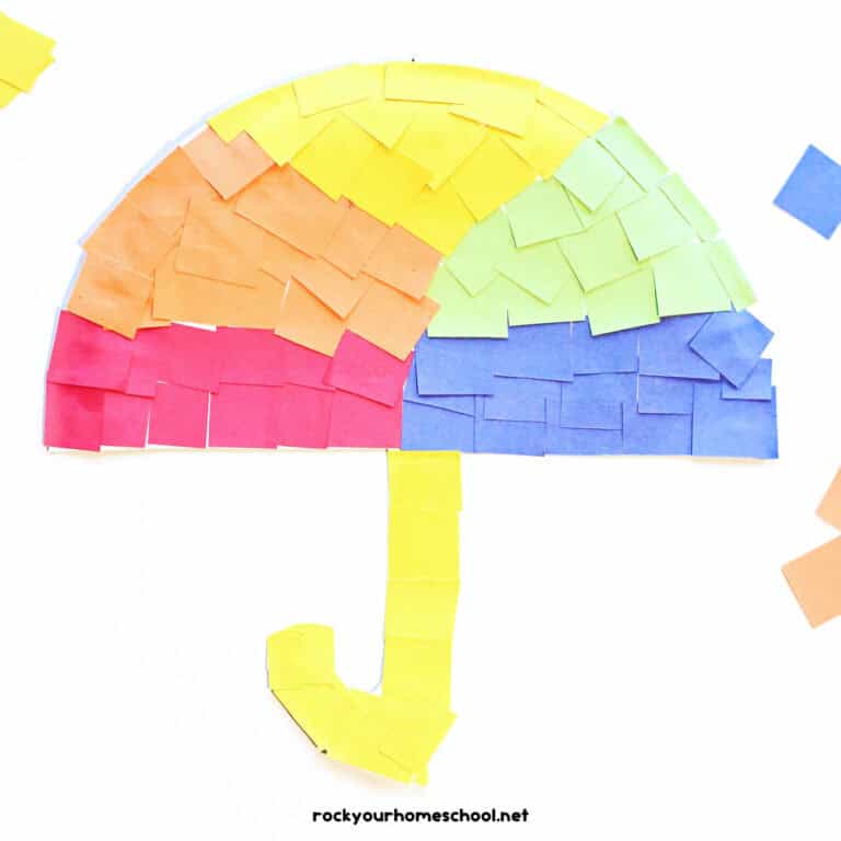 Example of paper plate umbrella craft in red, orange, yellow, green, and blue paper squares.