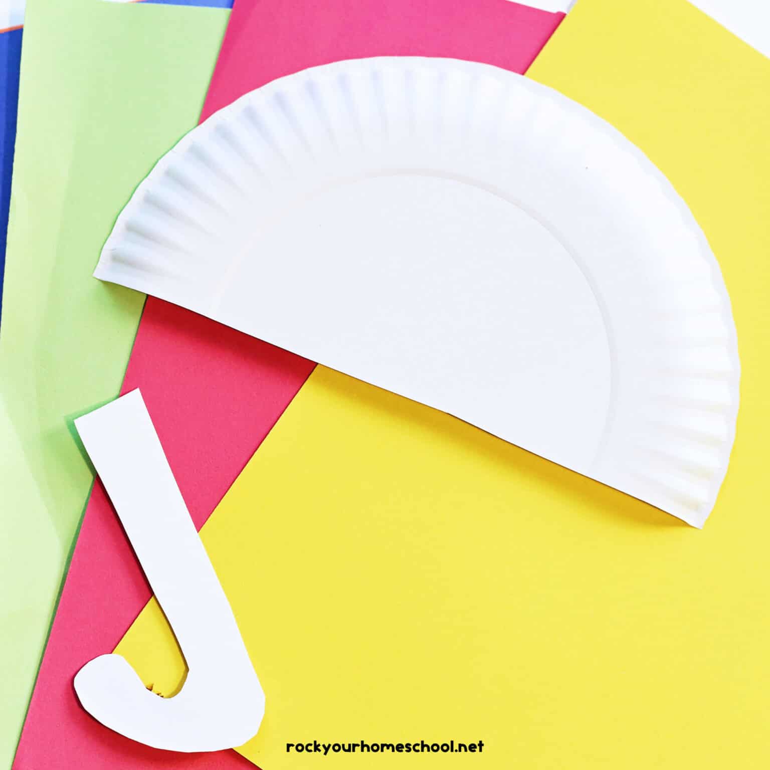 Construction paper with paper plate cute in half.