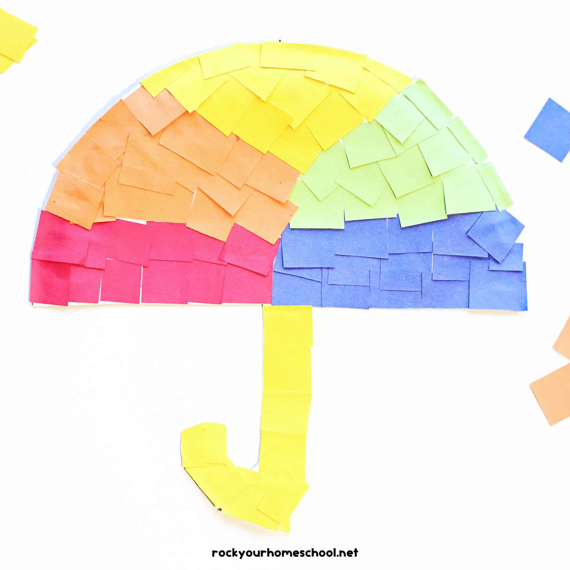 Example of paper plate umbrella craft in red, orange, yellow, green, and blue paper squares.