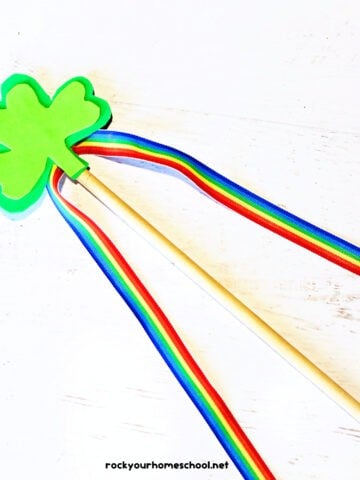 Example of shamrock craft for making a wand out of foam sheets, rainbow ribbon, and wood dowel.