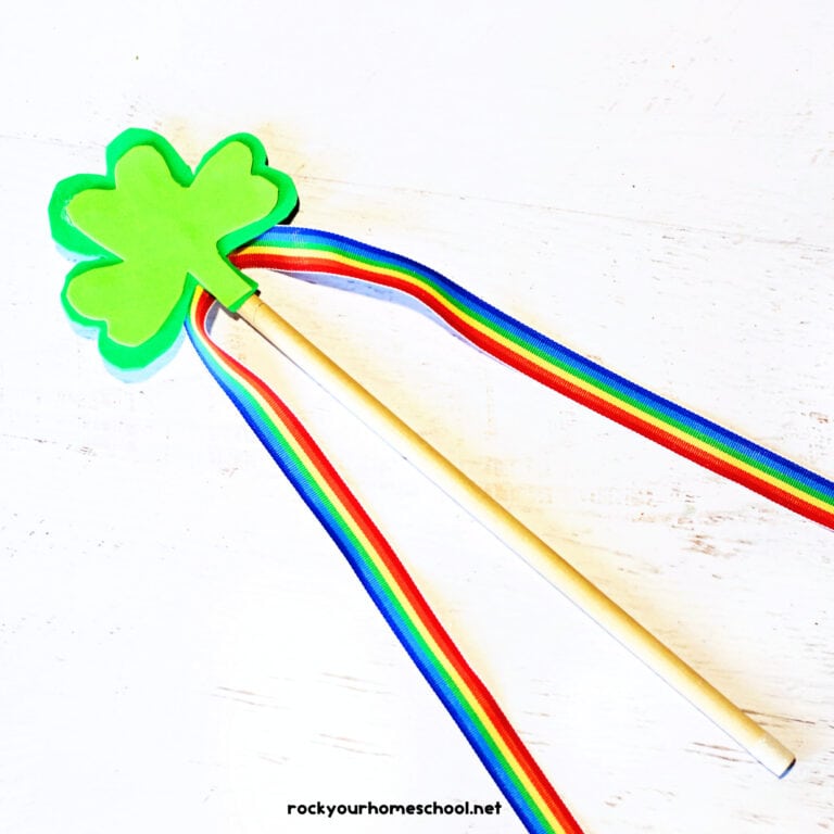 Example of shamrock craft for making a wand out of foam sheets, rainbow ribbon, and wood dowel.