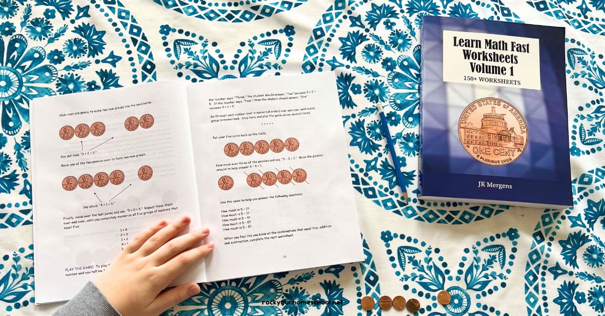 Boy working on basic math lesson with pennies and Learn Math Fast Volume 1 book and worksheets.