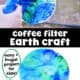 Person using blue spray bottle with water on coffee filter with blue and green and example of coffee filter Earth craft.