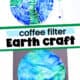 Coffee filter and green and blue markers and example of coffee filter Earth craft on black construction paper.