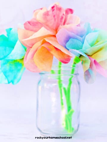 Colorful and easy coffee filter flowers with green pipe cleaner stems in glass jar.