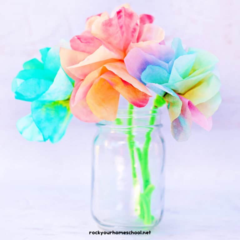 Colorful and easy coffee filter flowers with green pipe cleaner stems in glass jar.