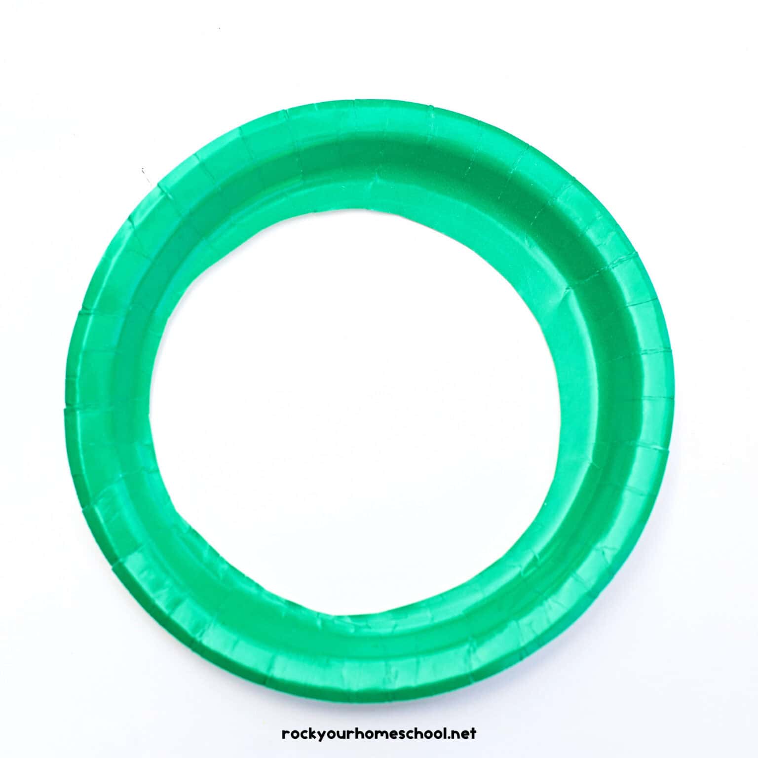 Green paper plate with center cut out.