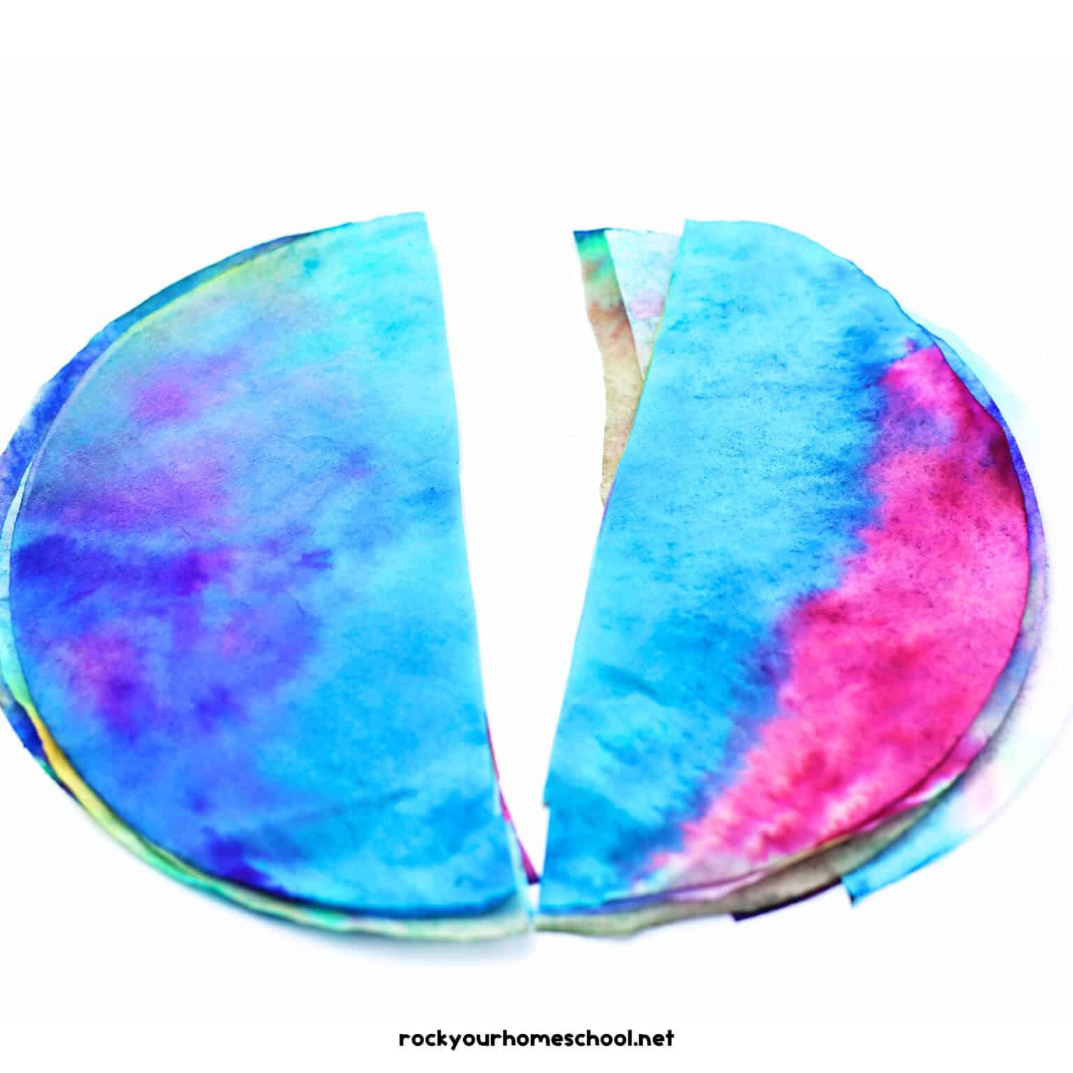 Stack of coffee filters with marker colors cut in half.