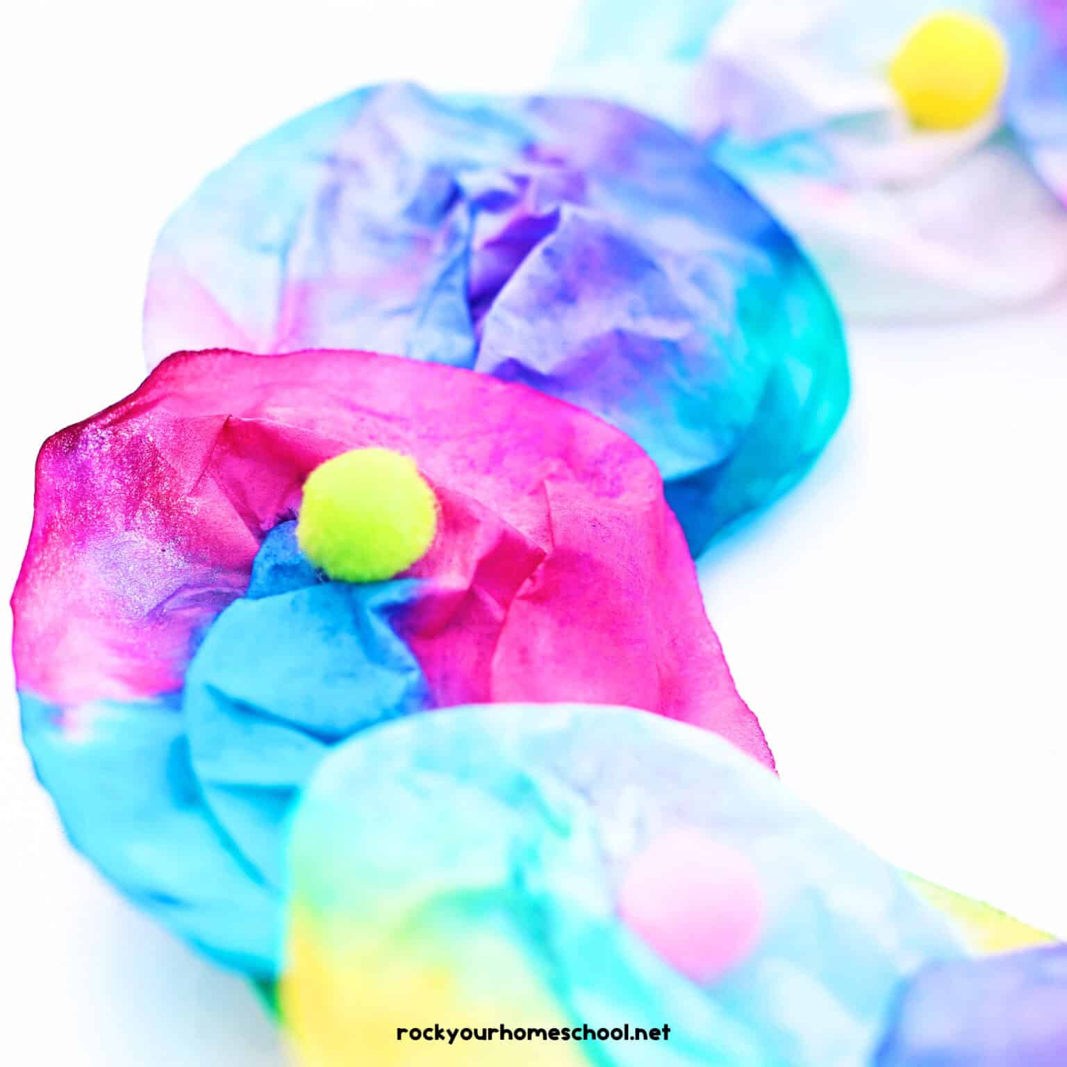Coffee filter flowers with yellow pom poms.