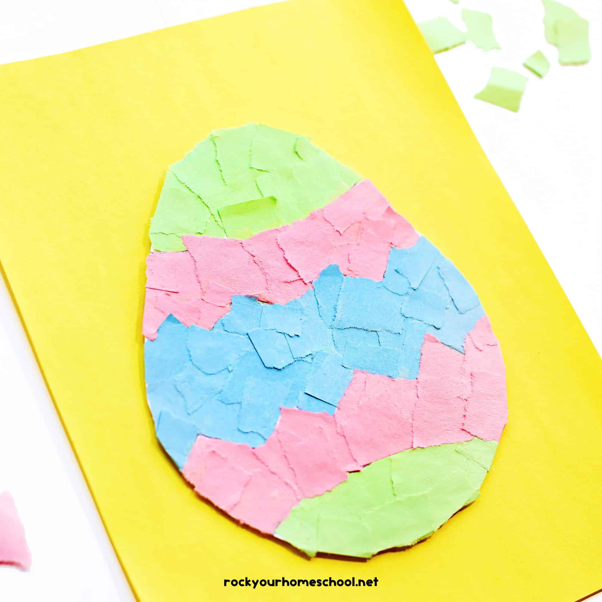 Example of torn paper Easter egg craft for kids on yellow paper.