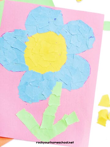 Example of torn paper flowers craft with light blue, yellow, and green on pink paper.