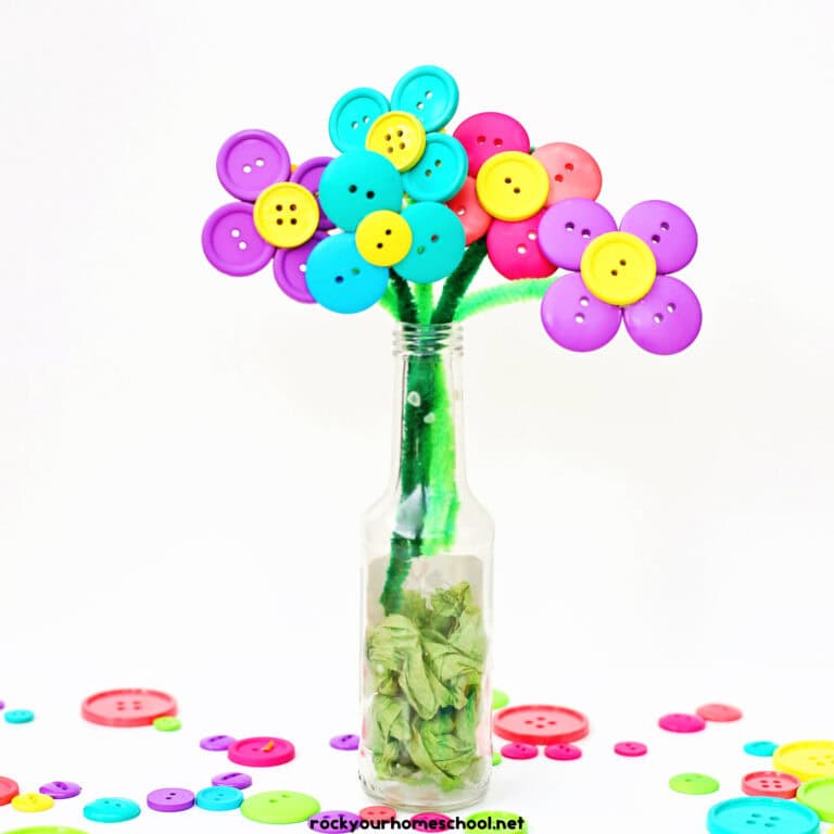 Examples of button flowers with pipe cleaners in glass vase.