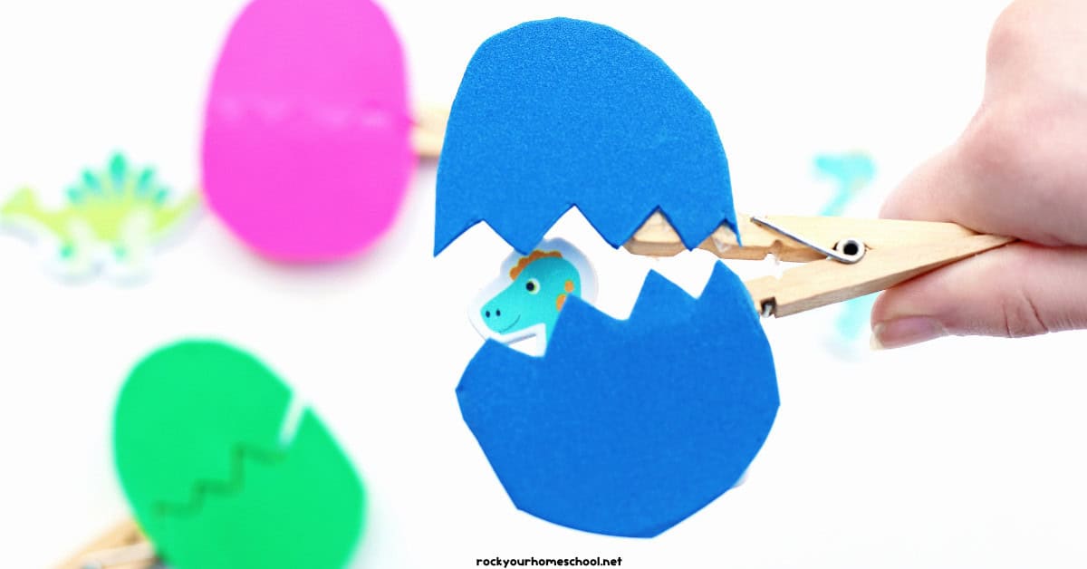Blue foam egg on clothespin and dinosaur sticker.