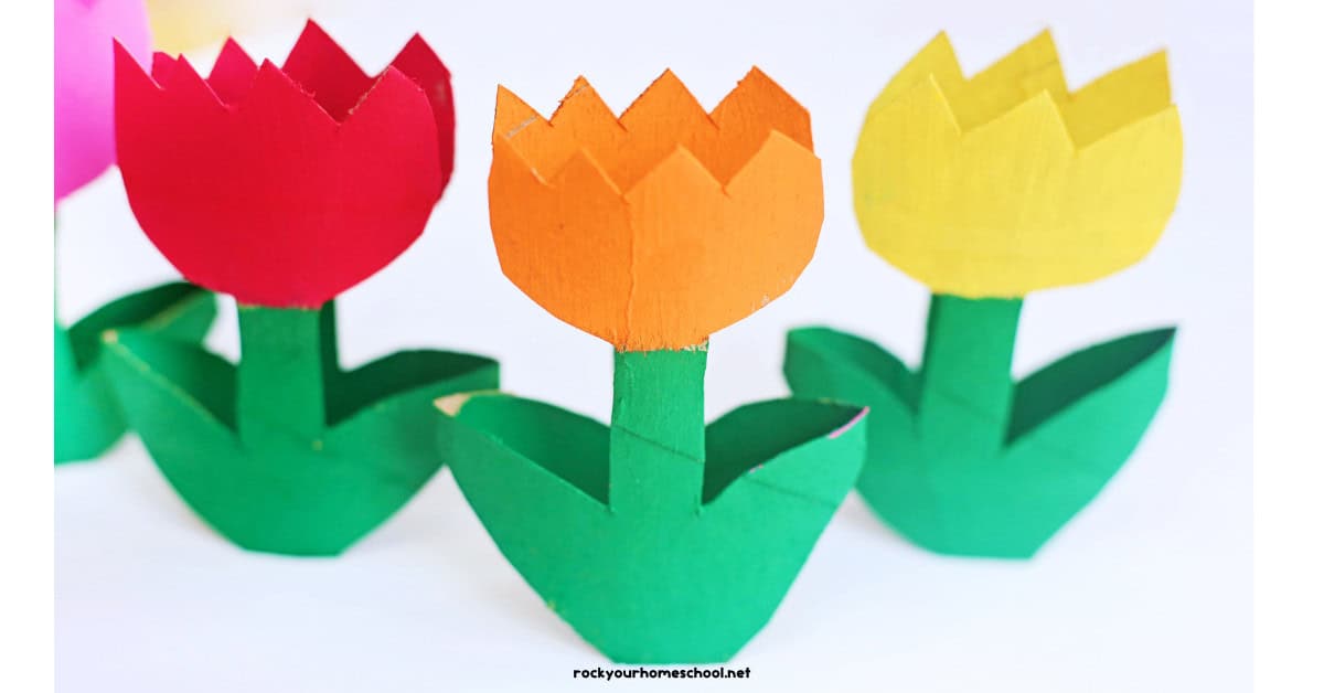 Three examples of toilet paper roll tulips in red, orange, and yellow.