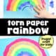 Child adding torn piece of blue paper to torn paper rainbow craft.