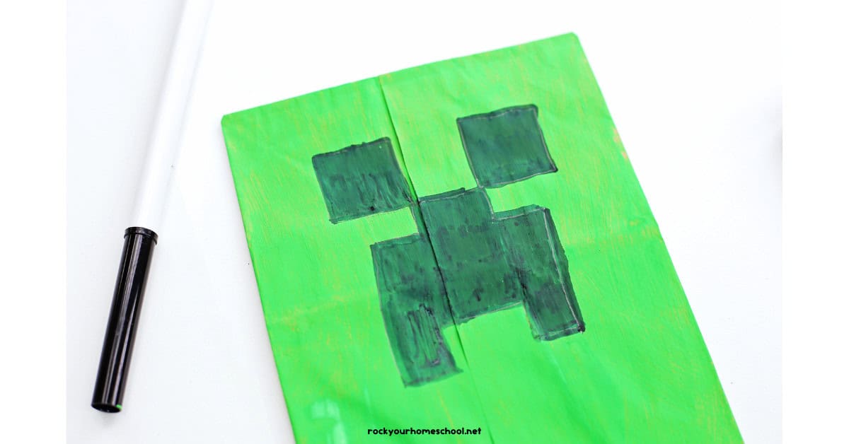 Green paper bag with black marker to draw Creeper face.