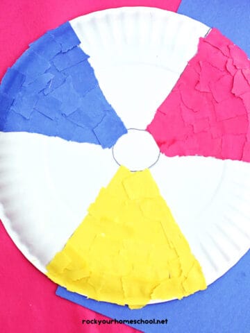 Example of paper plate beach ball craft made with red, yellow, and blue torn construction paper.
