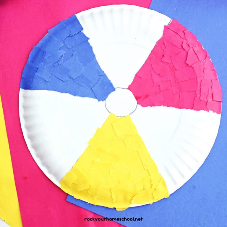Example of paper plate beach ball craft made with red, yellow, and blue torn construction paper.
