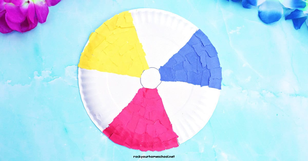 Example of paper plate beach ball craft with yellow, blue, and red torn paper.