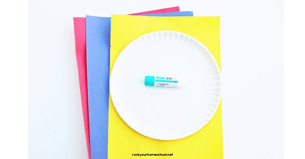 Red, blue, yellow, paper plate, and glue stick.