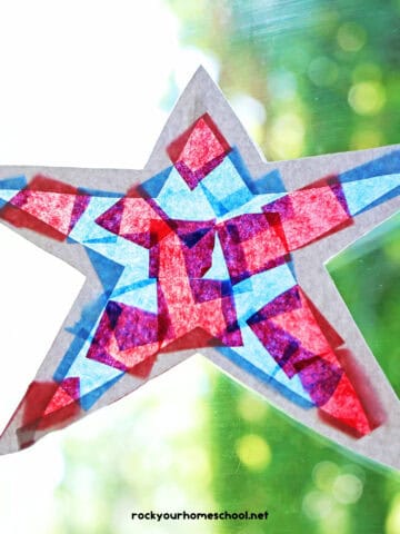 Example of patriotic suncatcher made with blue and red tissue paper, white cardstock, and clear contact paper.