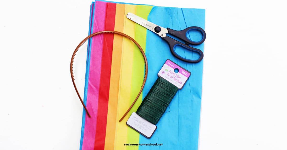 Tissue paper in pink, red, orange, yellow, lime green, and light blue colors with scissors, floral wire, and headband.