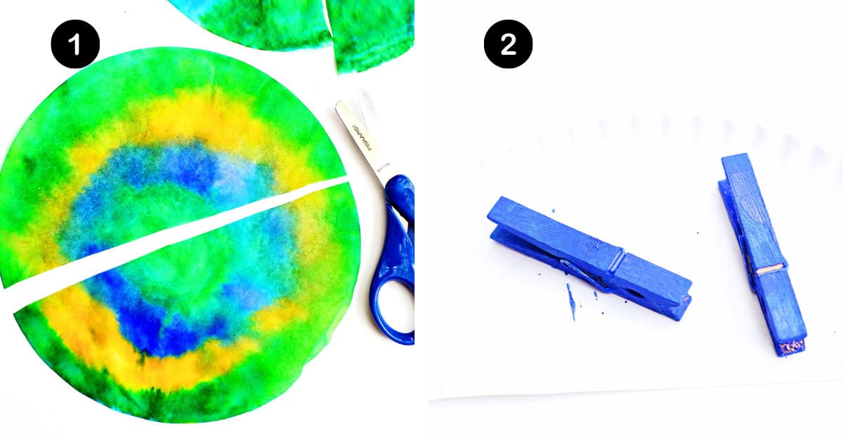 Coffee filter colored green, yellow, and blue sprayed with water, dried, and cut in half with clothespins painted blue.