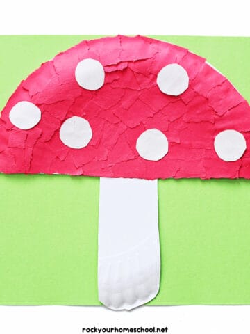 Example of paper plate mushroom craft made with red torn paper pieces and white paper circles.