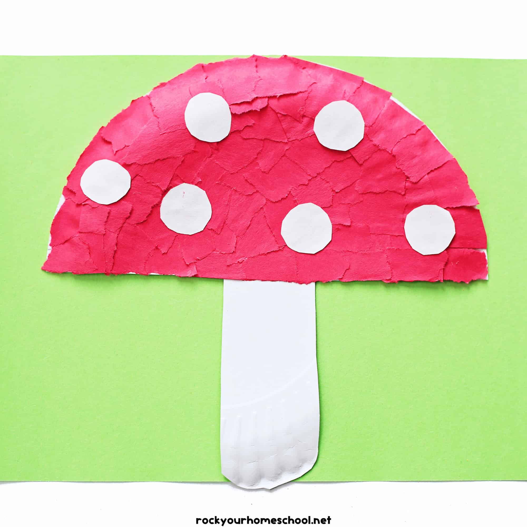 Example of paper plate mushroom craft made with red torn paper pieces and white paper circles.