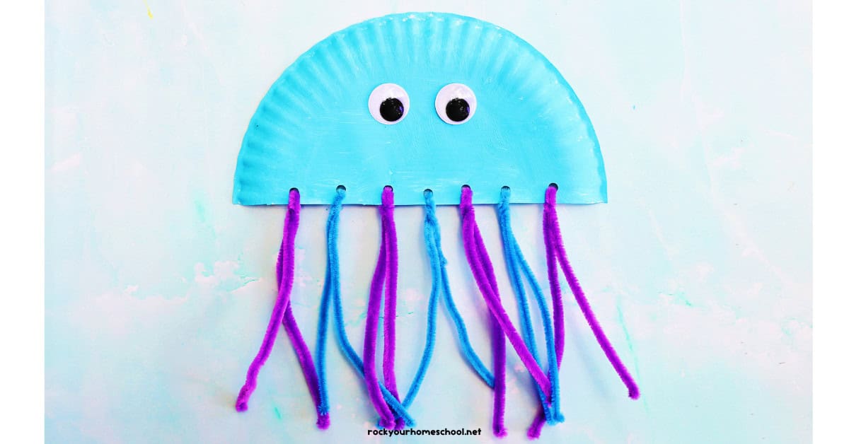 Example of light blue paper plate jellyfish craft with pipe cleaner tentacles and googly eyes.