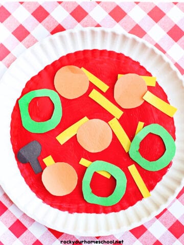 Example of paper plate pizza craft with construction paper toppings and red checker paper.