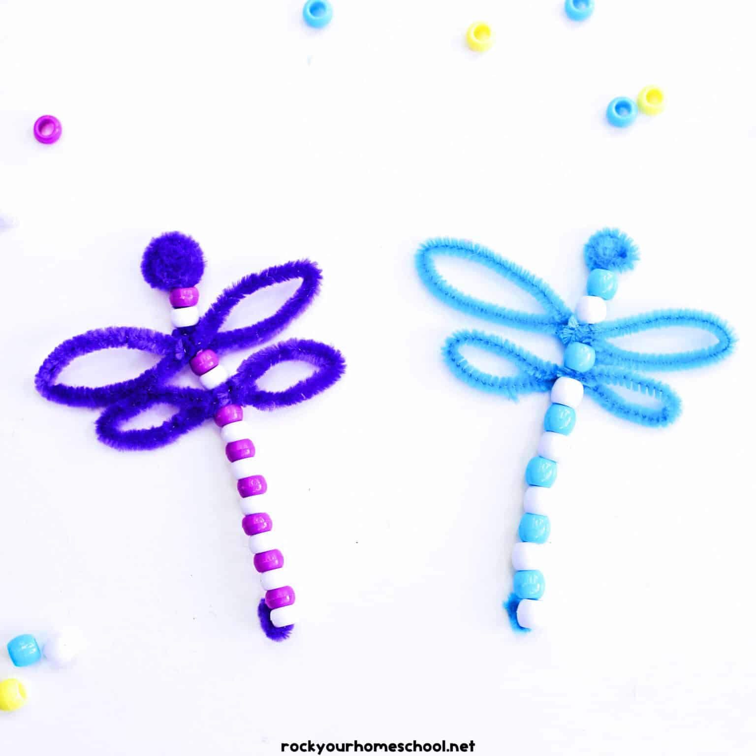 Two examples (in purple in blue) of pipe cleaner dragonflies.