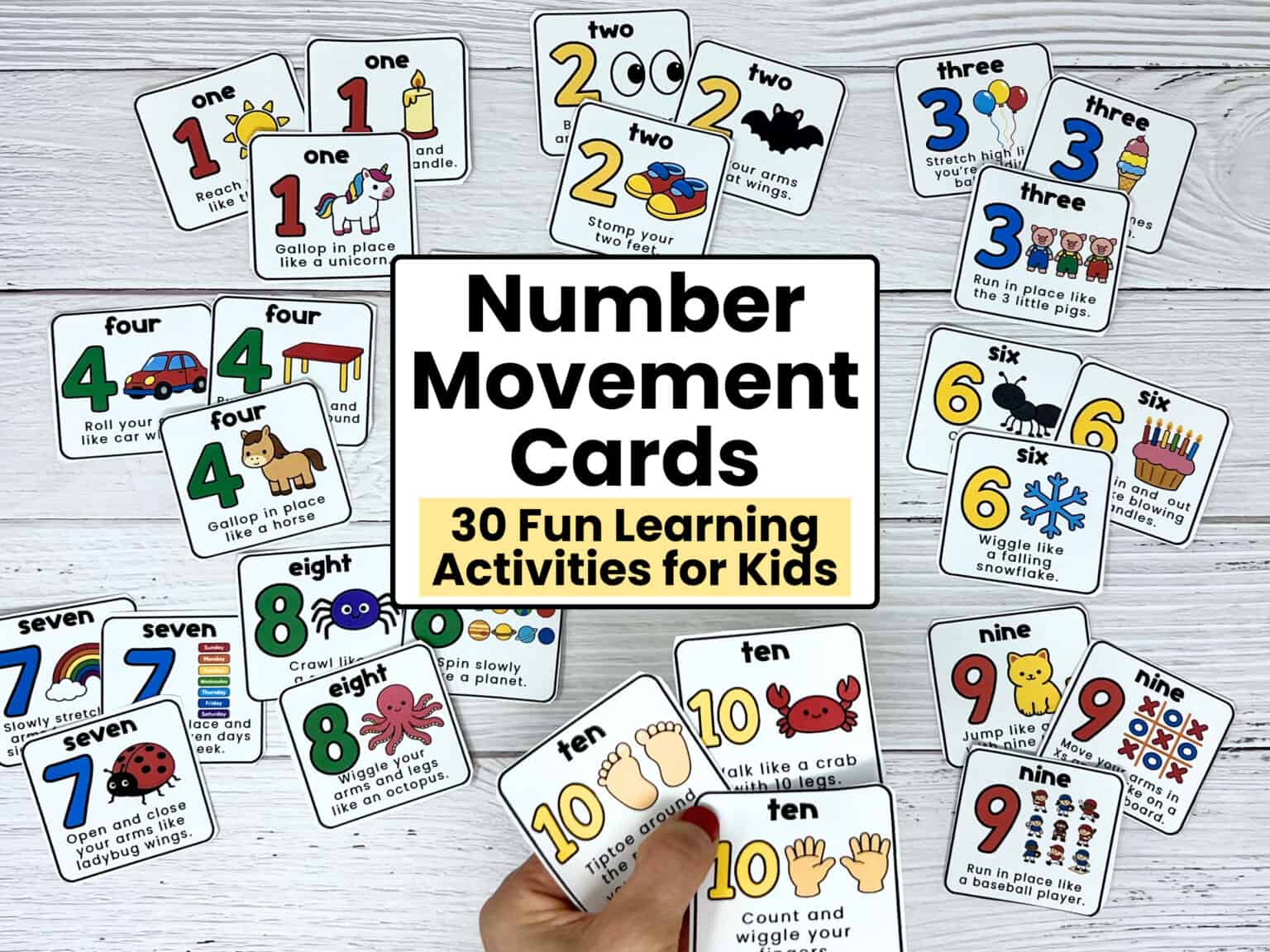 Woman holding examples of number 10 movement cards with fun prompts with the other cards from this printable set in the background.