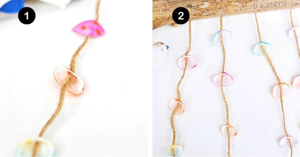 Painted white seashells on twine and hanging from drift wood.