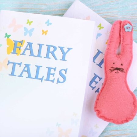 Pink felt bunny and fairy tale books to feature fairy tale activities for preschool.