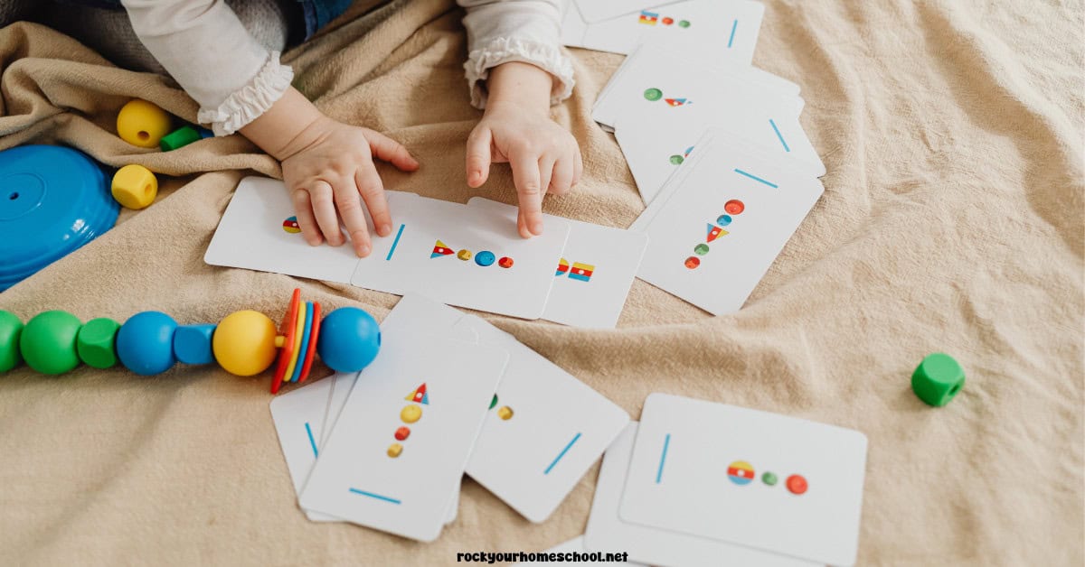 Child using shape pattern cards with beads.