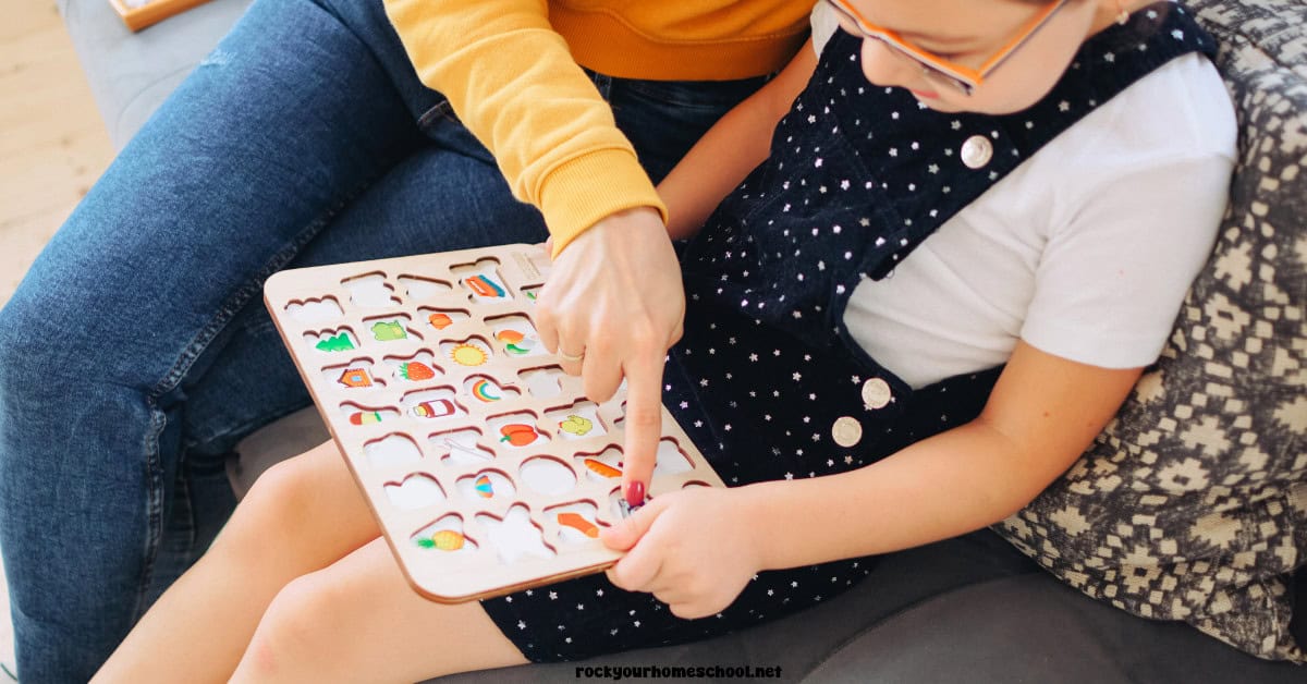 Mother and child using alphabet puzzle.