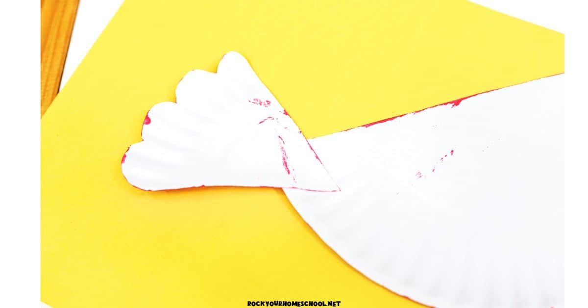 Paper plate tail glued onto hen craft.